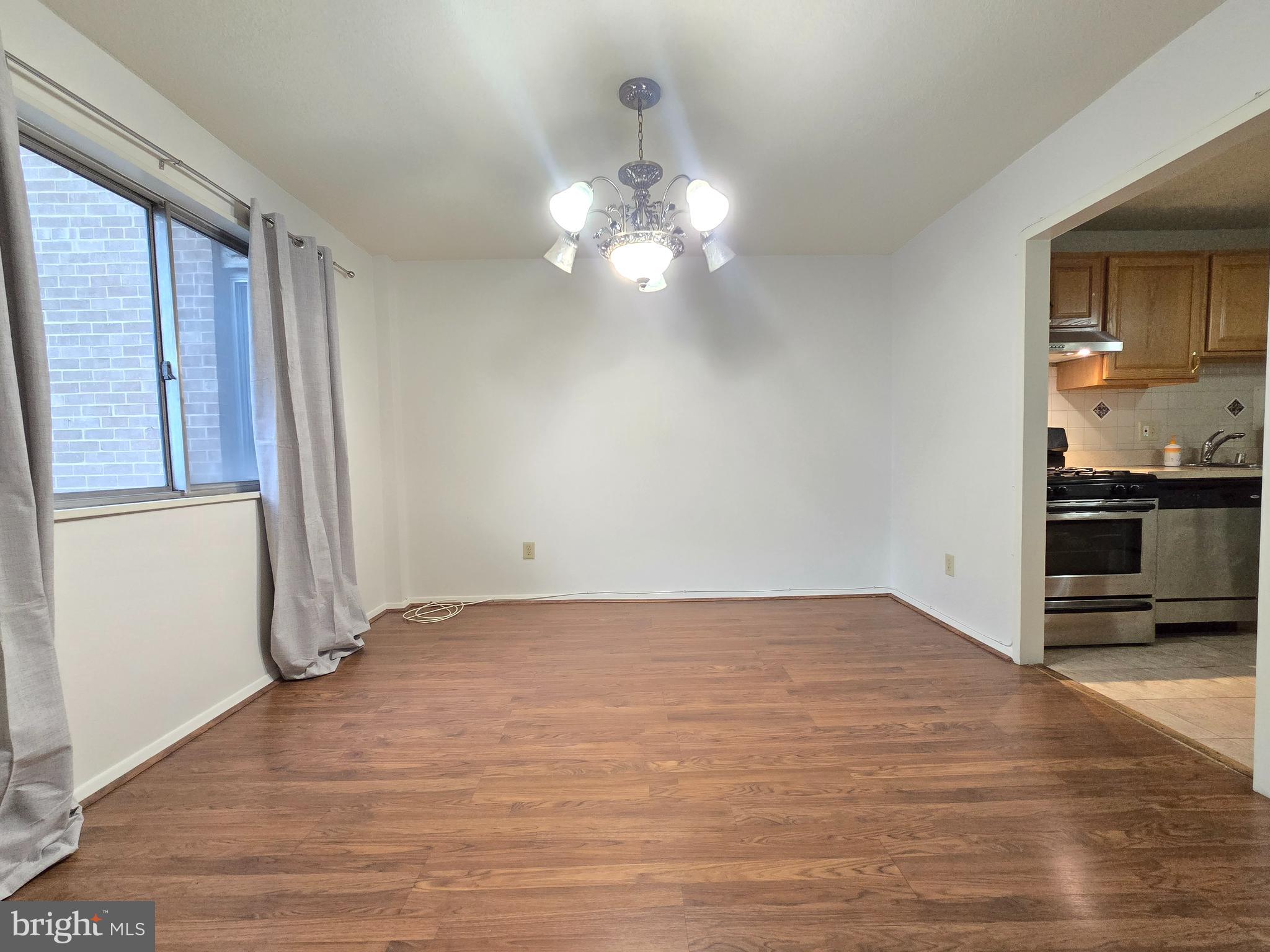 1836 Metzerott Road, Unit 1524 Hyattsville, MD 20783 - Photo 14 of 22 a view of a kitchen with wooden floor and a ceiling fan