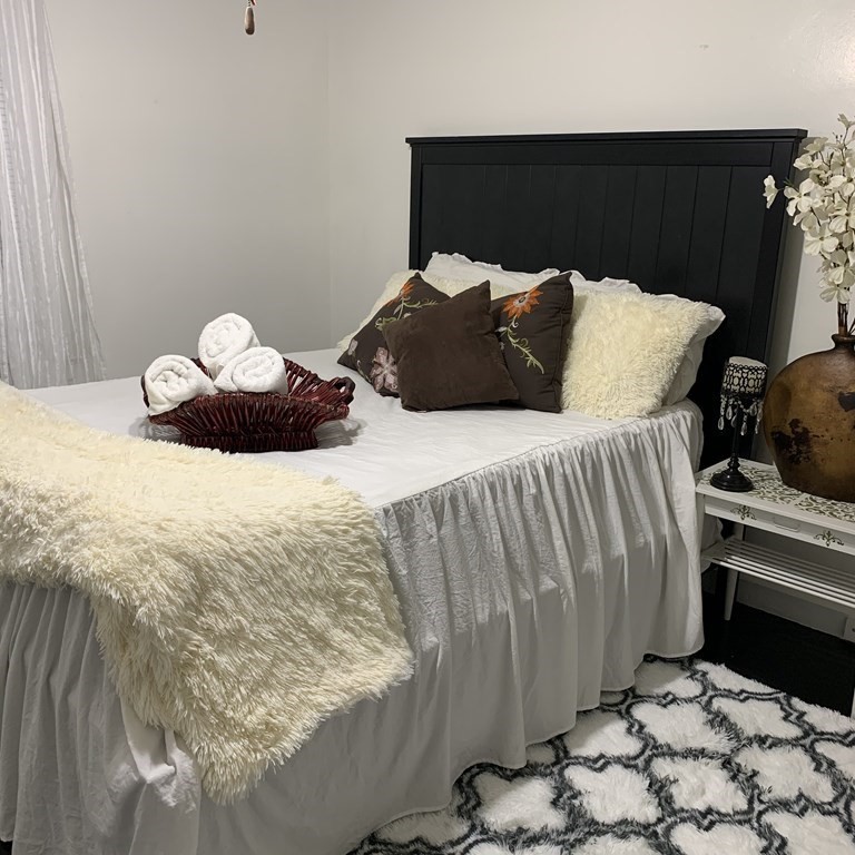 23 Notre Dame Street Springfield, MA 01104 - Photo 11 of 28 a bedroom with a bed and a chair