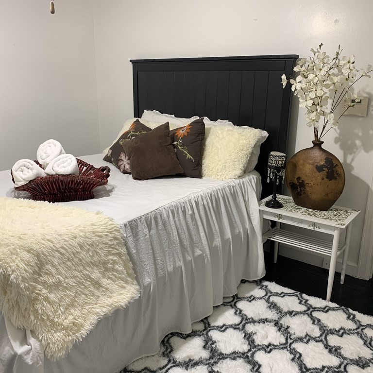 23 Notre Dame Street Springfield, MA 01104 - Photo 12 of 28 a bedroom with a bed and a potted plant