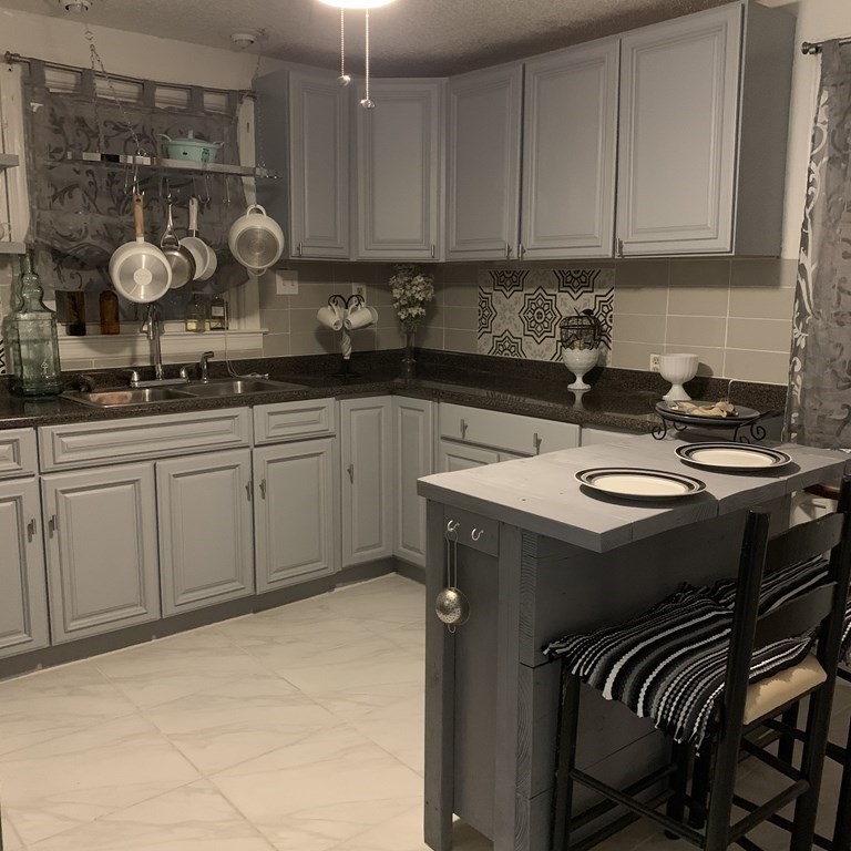 23 Notre Dame Street Springfield, MA 01104 - Photo 13 of 28 a kitchen with a sink and cabinets
