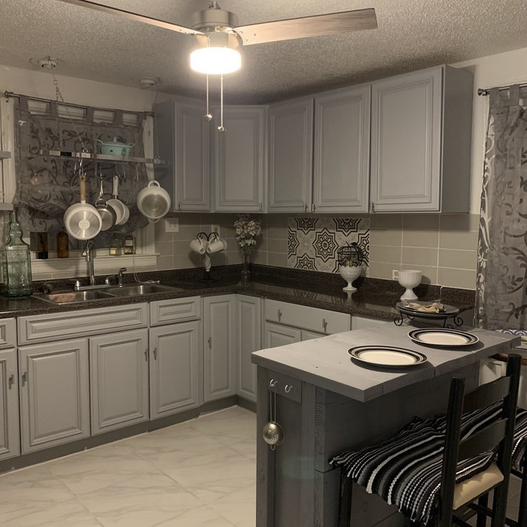 23 Notre Dame Street Springfield, MA 01104 - Photo 14 of 28 a kitchen with a sink and cabinets