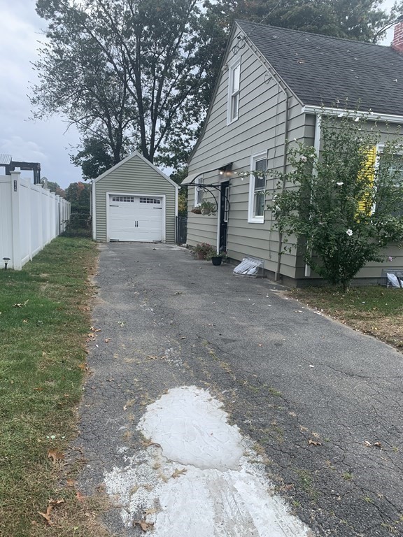 23 Notre Dame Street Springfield, MA 01104 - Photo 2 of 28 a view of a house with a yard and garage