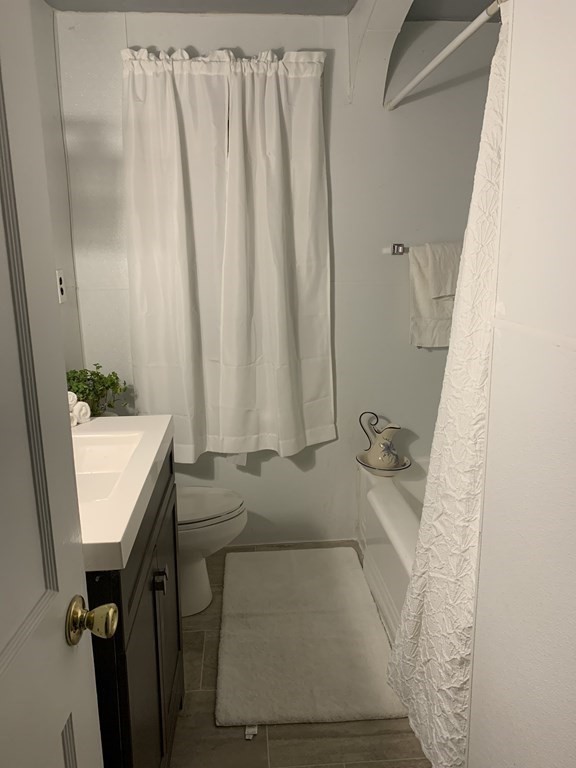 23 Notre Dame Street Springfield, MA 01104 - Photo 27 of 28 a bathroom with a granite countertop sink and a mirror