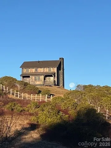 a front view of a building with mountain view