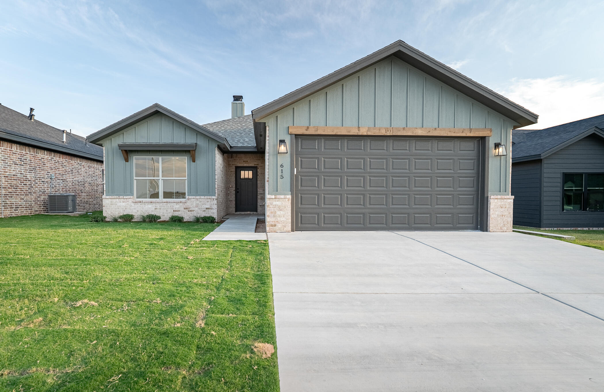 a front view of house with backyard and green space
