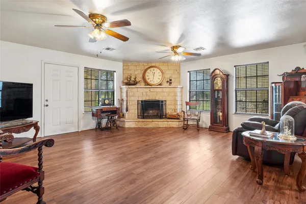 a living room with furniture a fireplace and a flat screen tv