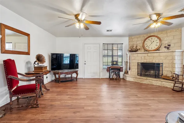 a living room with furniture a fireplace and a flat screen tv