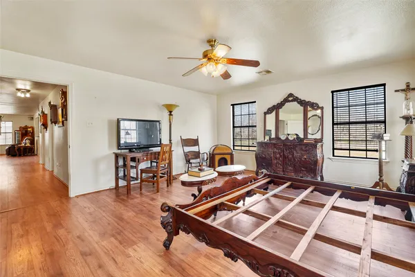 a living room with furniture a wooden floor and a window