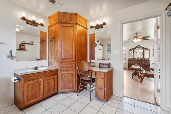 a bathroom with a bathtub shower sink vanity and a toilet