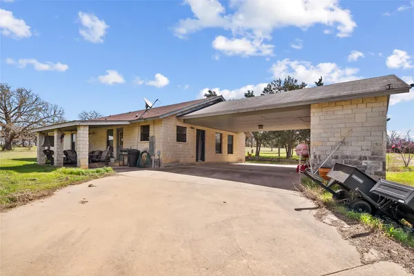 a front view of a house with a yard and outdoor seating