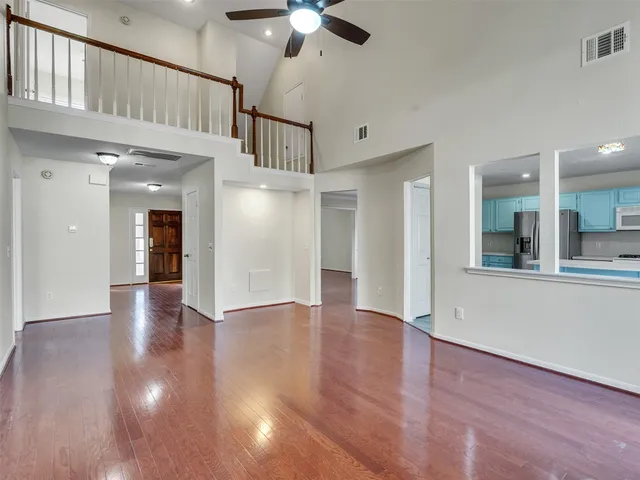 a view of an entryway with wooden floor and a chandelier