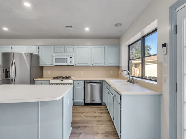 a kitchen with a sink stove and refrigerator