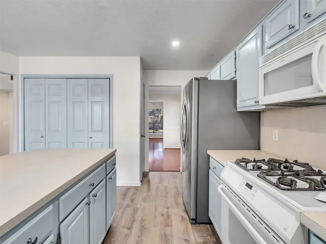 a kitchen with a stove and a refrigerator