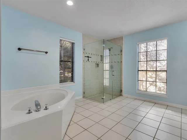 a bathroom with a bathtub and shower