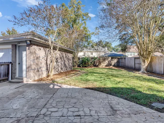 a view of a house with a yard and tree s