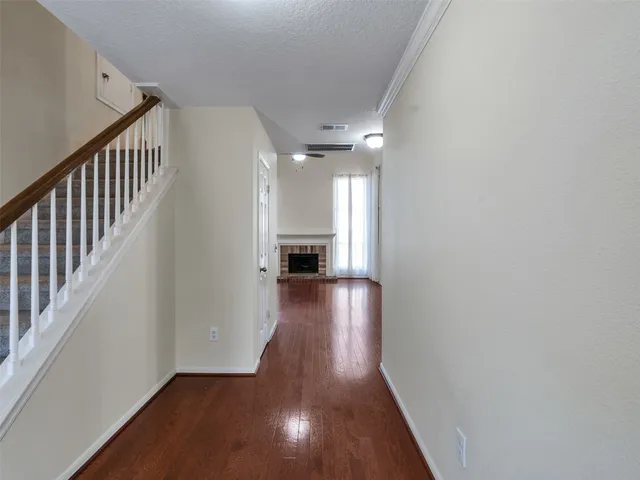a view of a hallway view with wooden floor and staircase