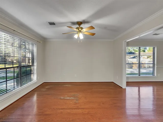 wooden floor in an empty room with a window