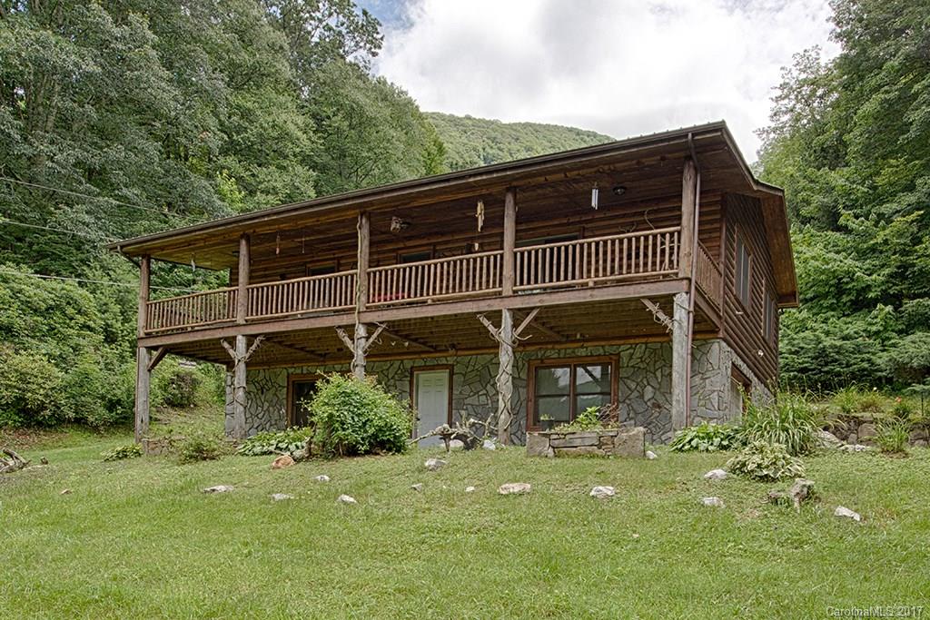 95 Straightup Road Maggie Valley, NC 28751 - Photo 1 of 24 a front view of a house with a garden