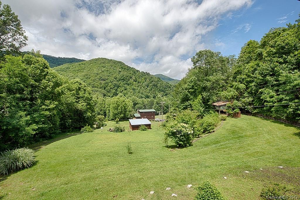 95 Straightup Road Maggie Valley, NC 28751 - Photo 22 of 24 a backyard of a building with lots of green space