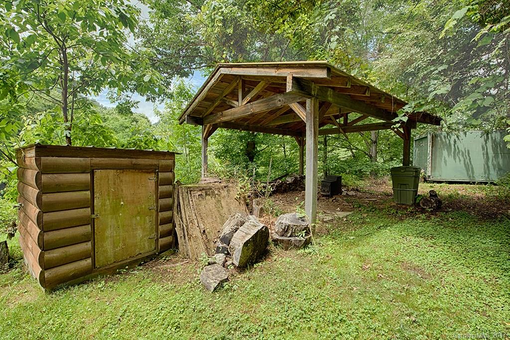95 Straightup Road Maggie Valley, NC 28751 - Photo 23 of 24 a view of a chair and table in the back yard of a house