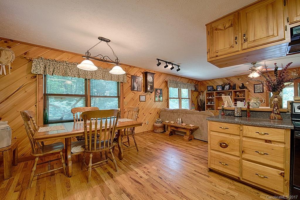 95 Straightup Road Maggie Valley, NC 28751 - Photo 4 of 24 a dining hall with stainless steel appliances granite countertop a stove and a dining table with wooden floor