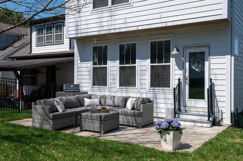 a building outdoor space with patio furniture and potted plants