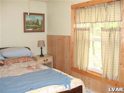 415 Roberts Road Effort, PA 18330 - Photo 5 of 5 a bedroom with a bed and a window