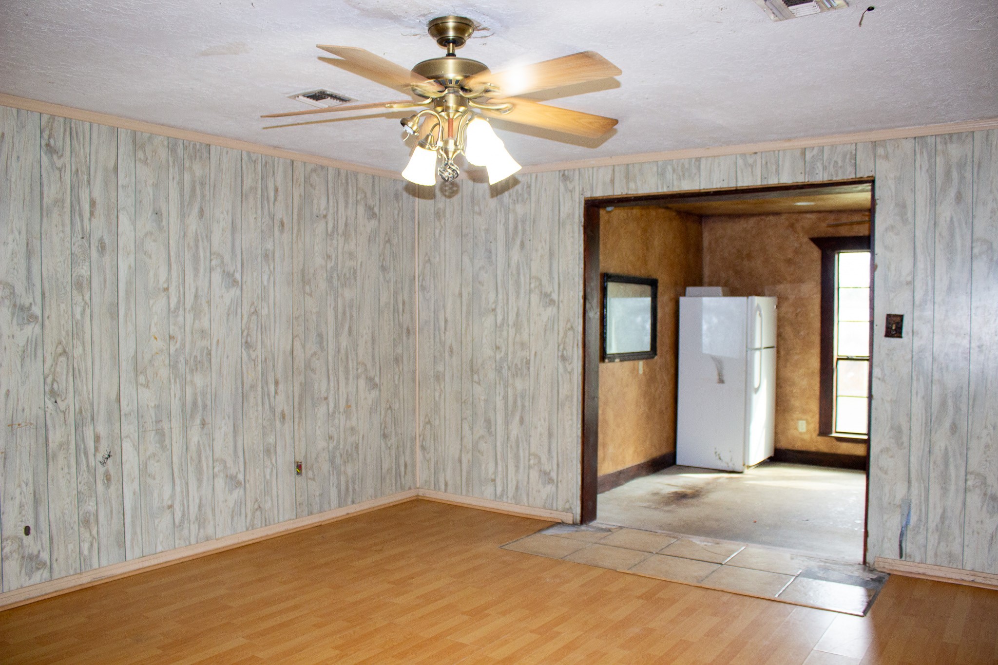 24765 Wicklow Road Hempstead, TX 77445 - Photo 22 of 29 a view of a hallway with a chandelier fan and wooden floor