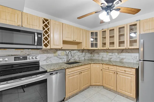 a kitchen with stainless steel appliances granite countertop a sink and cabinets