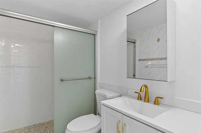 a bathroom with a sink a toilet and mirror