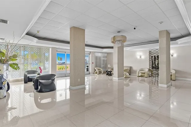 a hallway with a dining table and chandelier