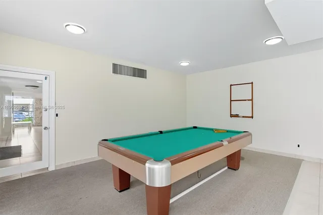 a room with pool table and window