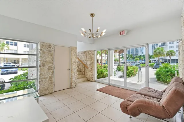 a living room with furniture and a floor to ceiling window