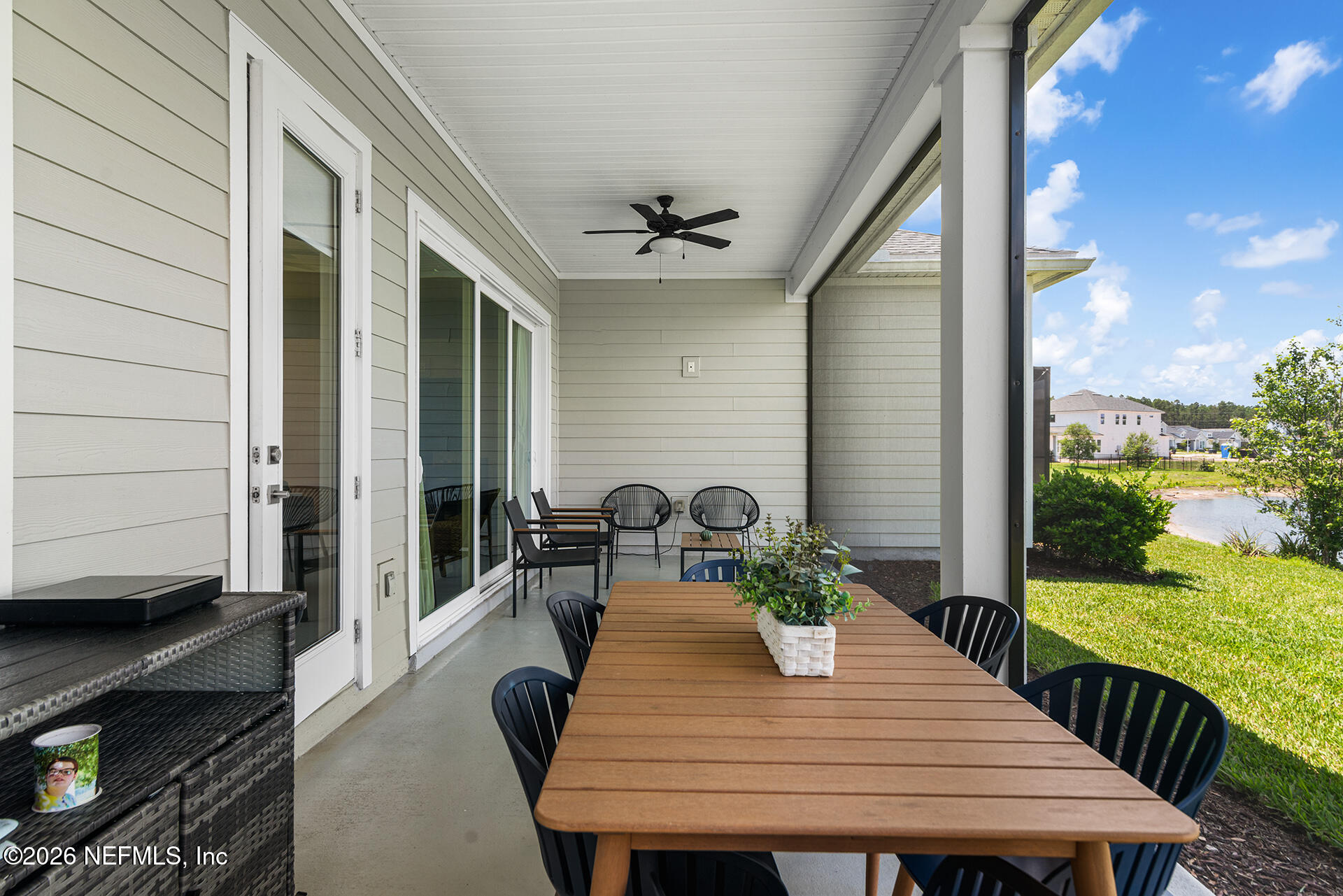 637 Navigators Road St. Johns, FL 32259 - Photo 27 of 42 a view of a patio with table and chairs with wooden floor and fence