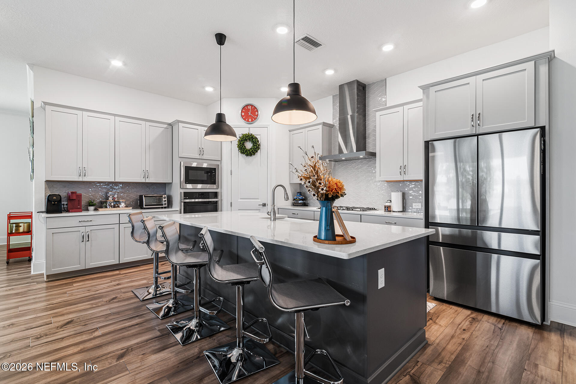 637 Navigators Road St. Johns, FL 32259 - Photo 7 of 42 a kitchen with kitchen island stainless steel appliances a dining table chairs sink and stove top oven