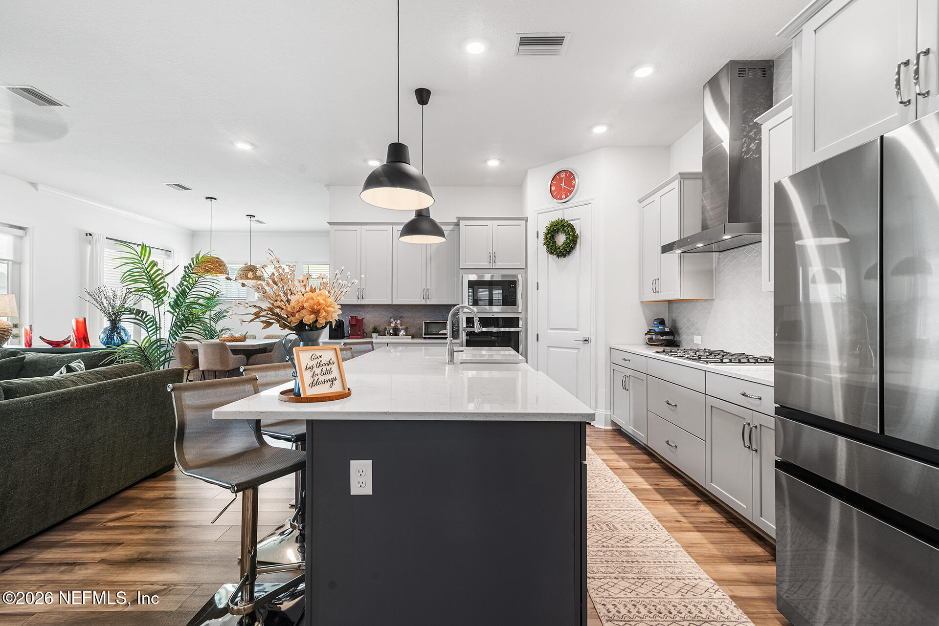 637 Navigators Road St. Johns, FL 32259 - Photo 8 of 42 a large kitchen with stainless steel appliances kitchen island granite countertop a sink and cabinets