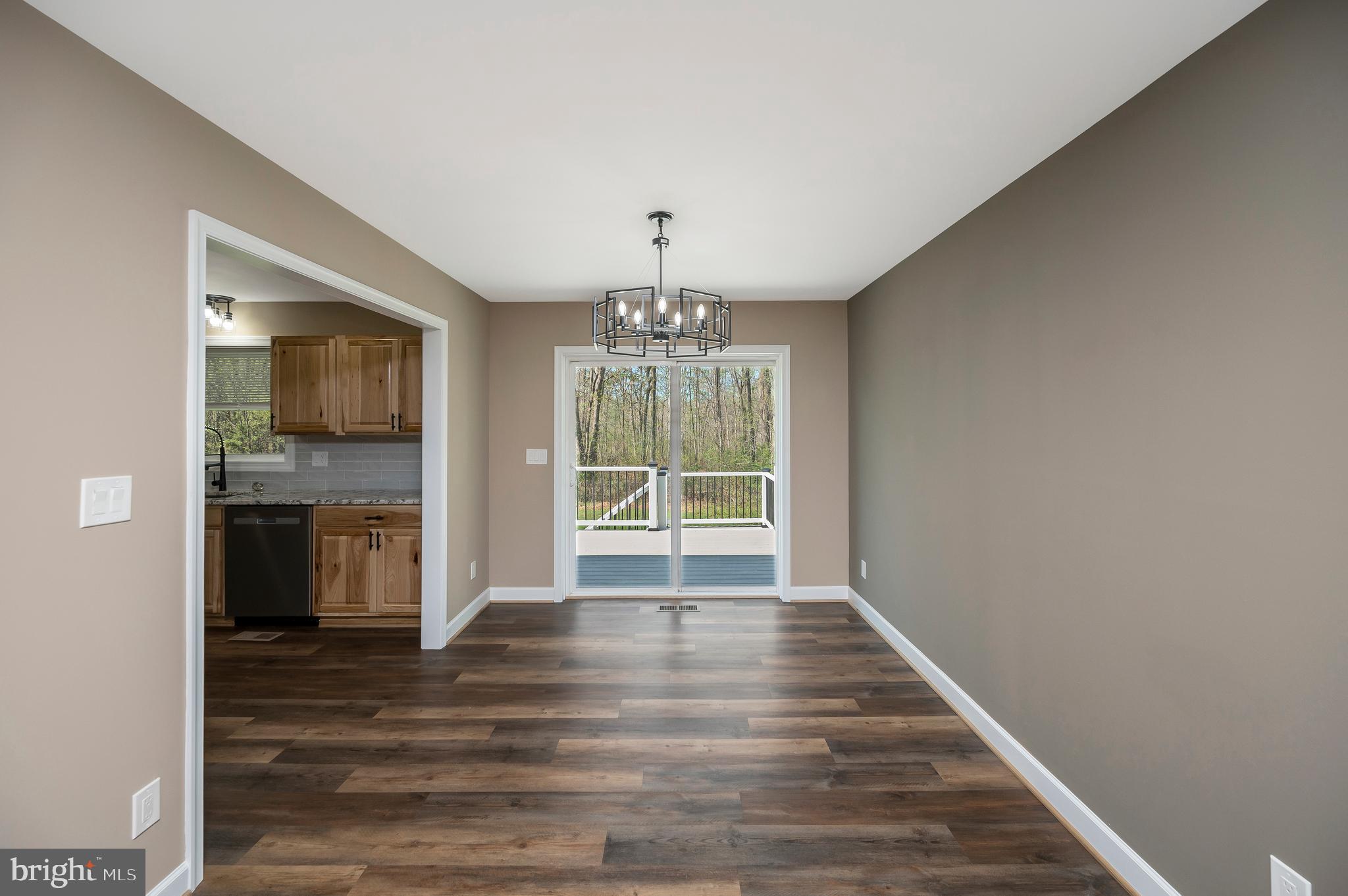 13452 Post Oak Road Spotsylvania, VA 22551 - Photo 22 of 56 a view of an empty room with a kitchen and a window