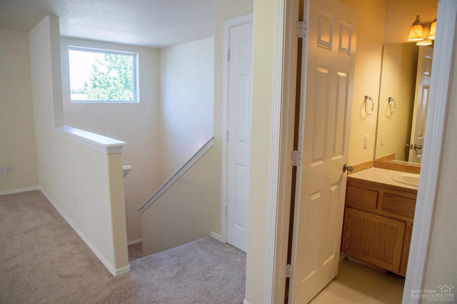 19967 Powers Road Bend, OR 97702 - Photo 15 of 22 Stairs lead to a bonus room and third fu