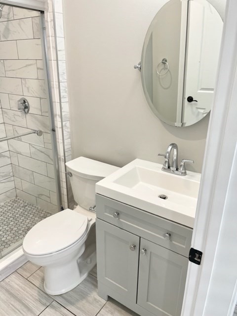 1 Ropes Street, Unit 2 Salem, MA 01970 - Photo 14 of 16 a white toilet sitting next to a bathroom sink