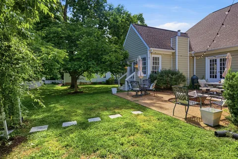 a view of a house with backyard sitting area and garden