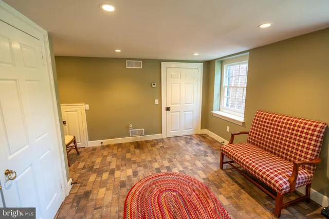 a living room with furniture a flat screen tv and a table