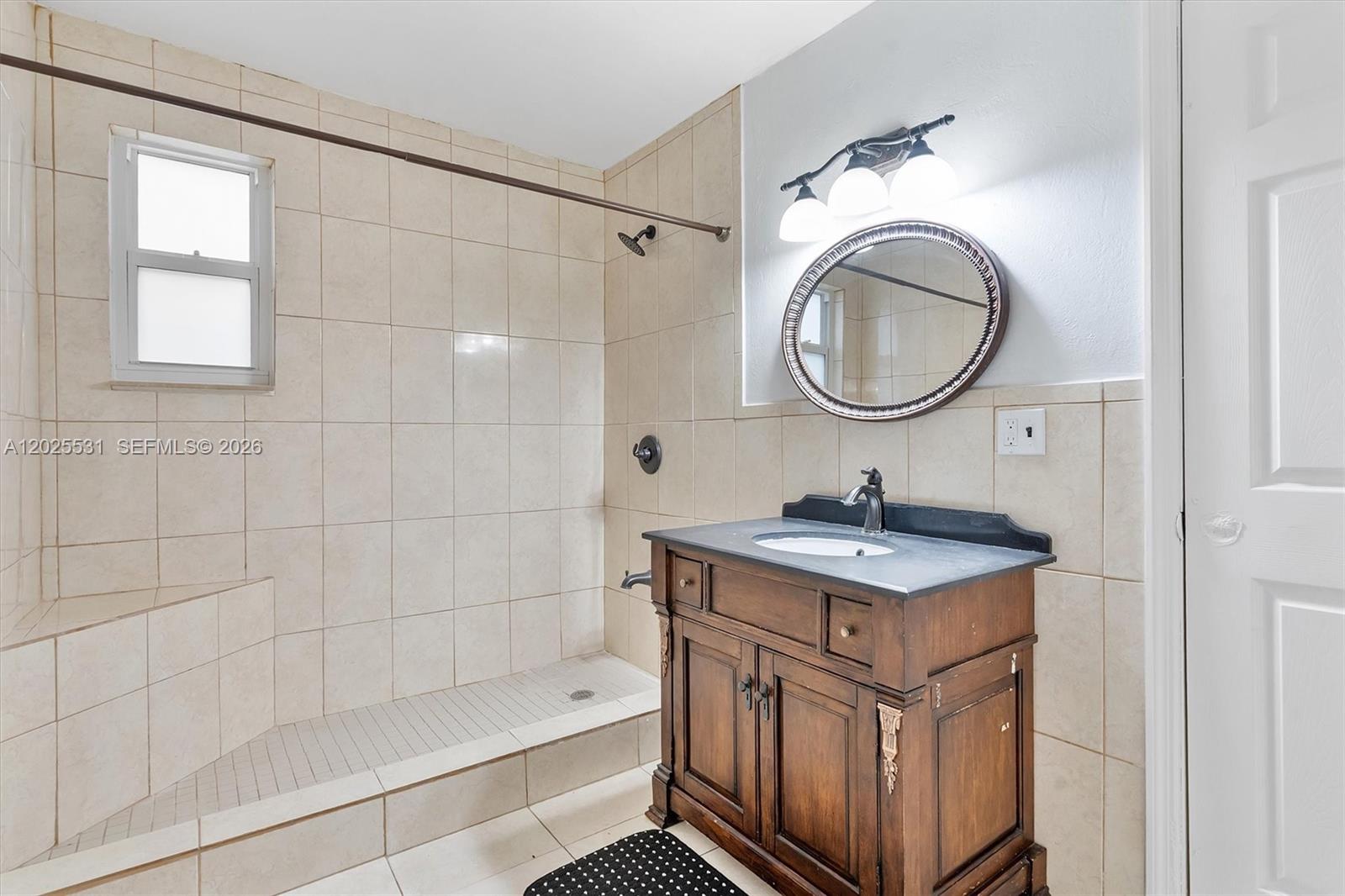 3951 Southwest 2nd Terrace, Unit 3951 Miami, FL 33134 - Photo 20 of 21 a bathroom with a sink a mirror and a bathtub
