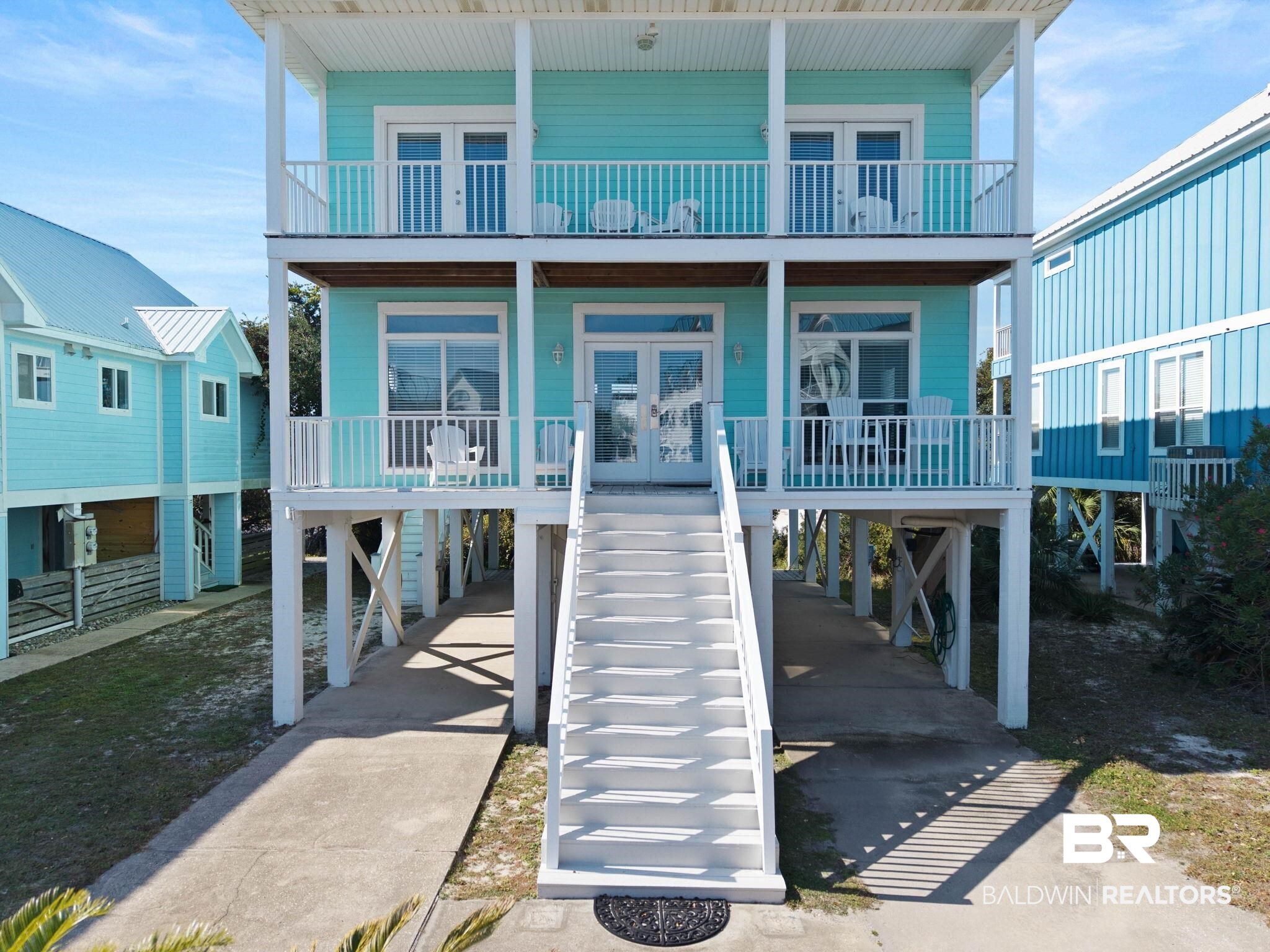 545 Plantation Road, Unit 3 Gulf Shores, AL 36542 - Photo 5 of 54 Back of house with french doors, a carport, covered porch, stairway, and driveway