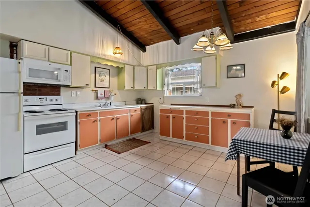 a kitchen with stainless steel appliances a stove a sink and a refrigerator