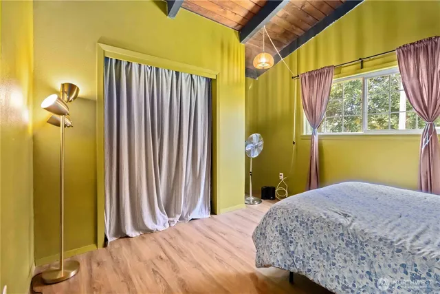 a bedroom with a bed and a window