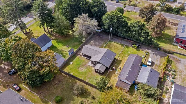 an aerial view of a house with garden space and swimming pool
