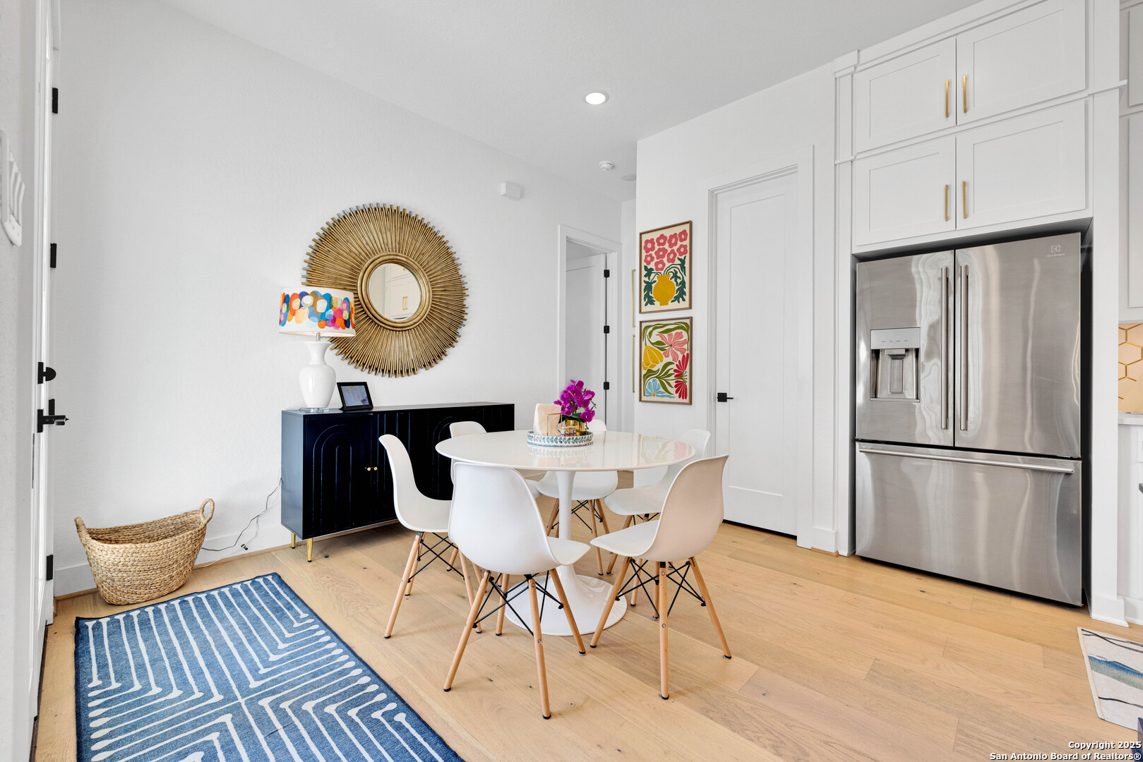 235 Corazon Boerne, TX 78006 - Photo 27 of 68 a kitchen with stainless steel appliances granite countertop a refrigerator a microwave a stove and a dining table with wooden floor