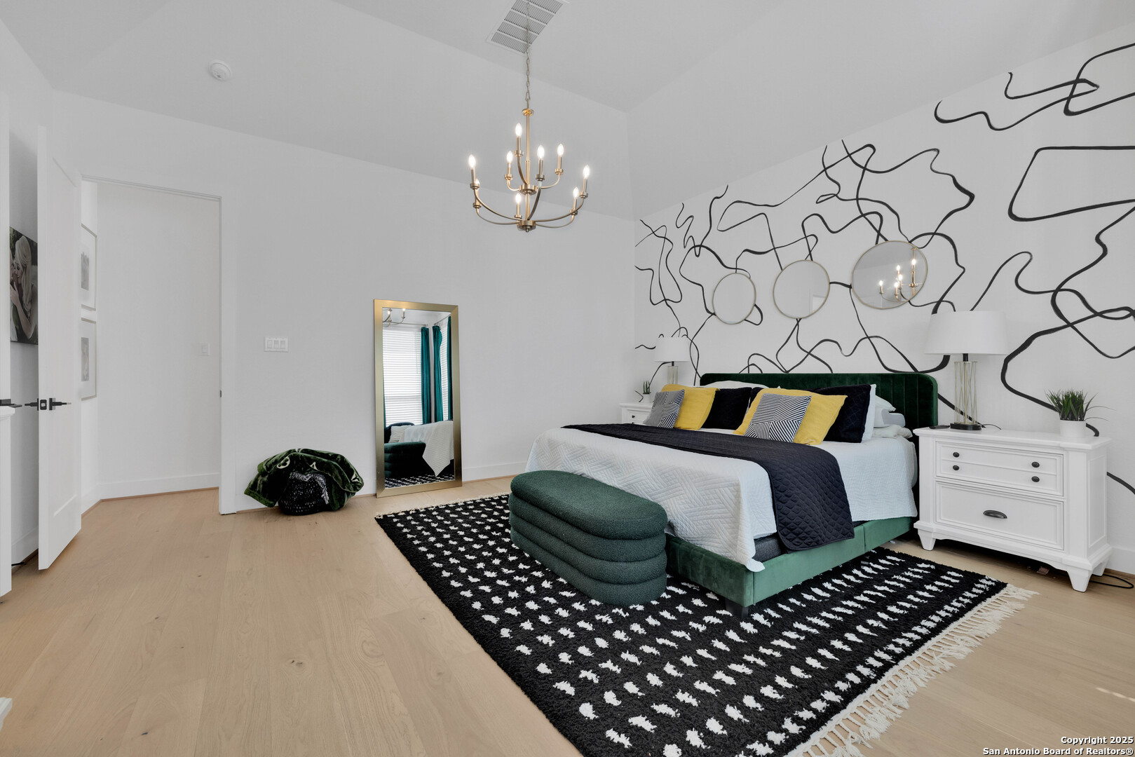 235 Corazon Boerne, TX 78006 - Photo 33 of 68 a bedroom with a bed and a chandelier