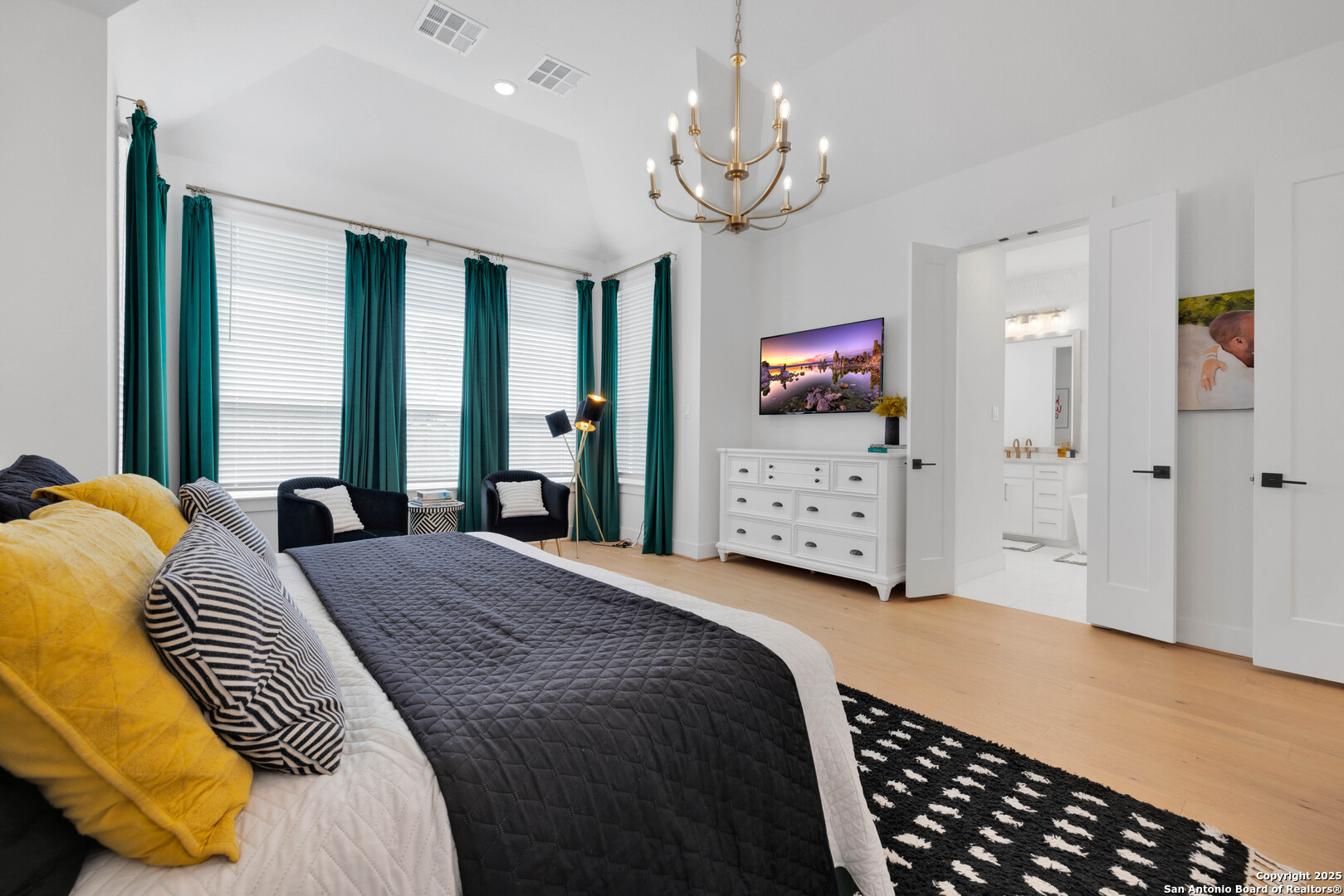 235 Corazon Boerne, TX 78006 - Photo 34 of 68 a bedroom with a bed and a chandelier