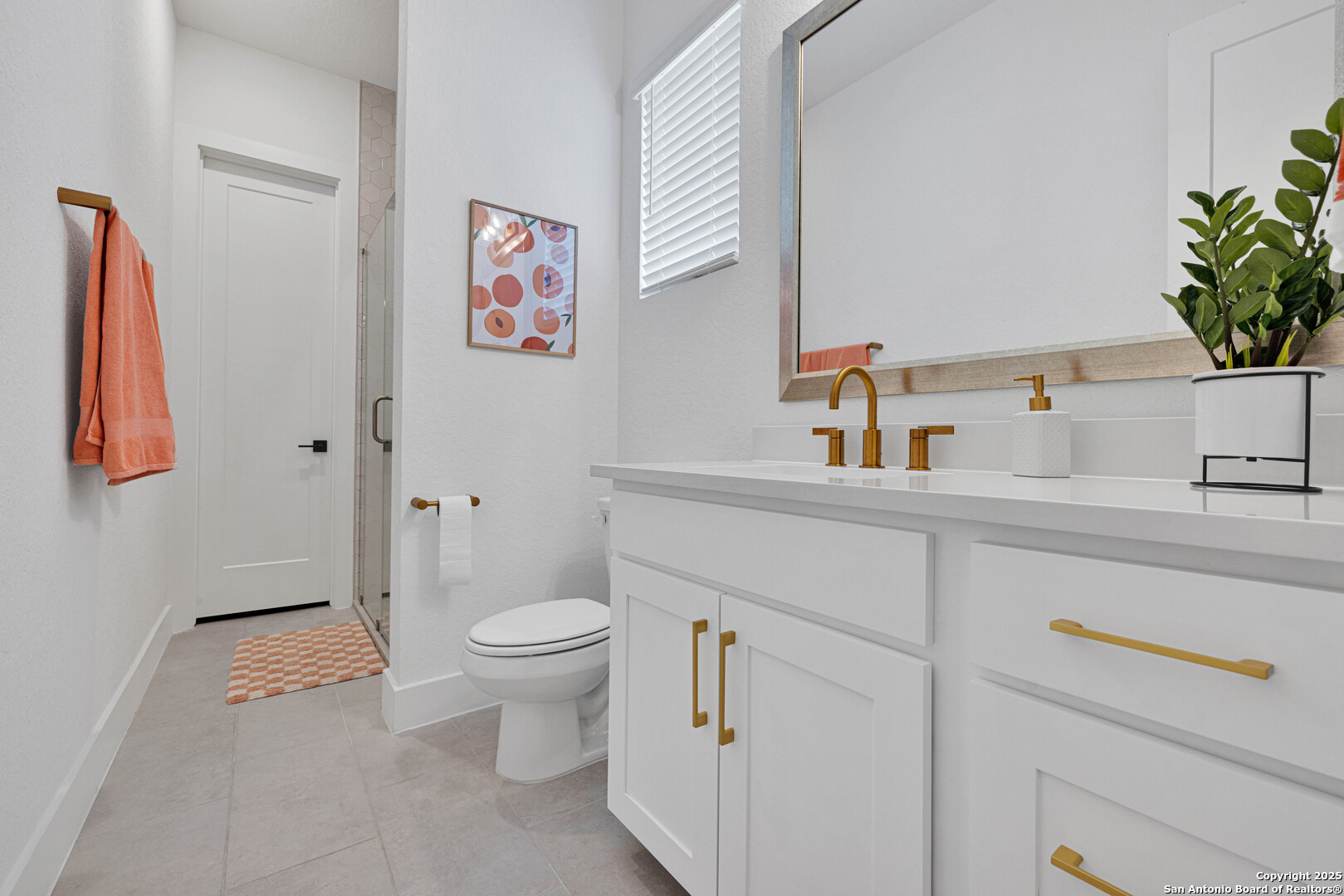 235 Corazon Boerne, TX 78006 - Photo 42 of 68 a bathroom with a toilet sink and a large mirror